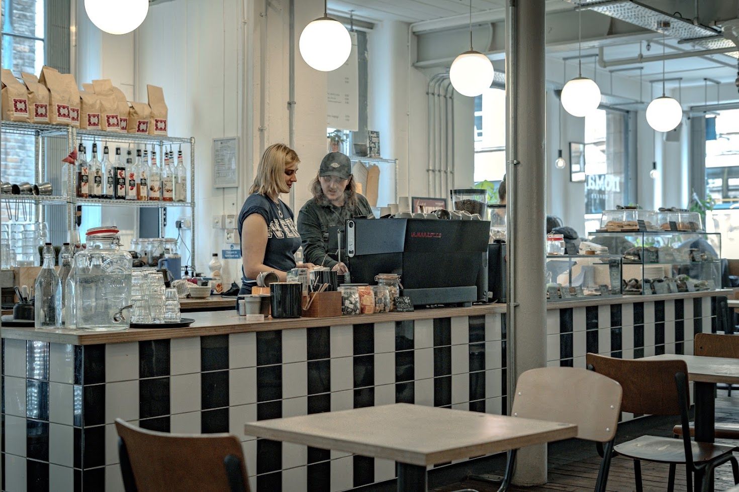 Baristas behind the counter at Nomad Coffee, Northern Quarter, Manchester
